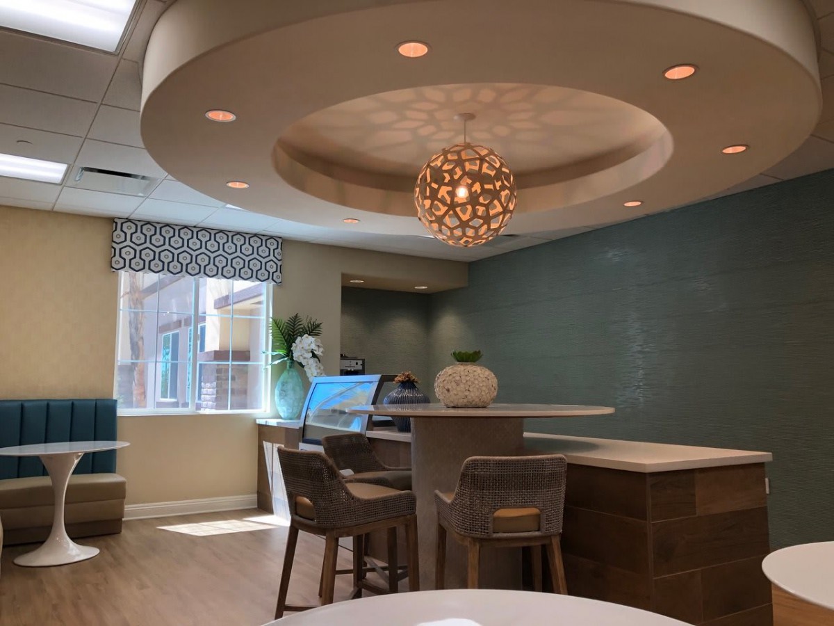 A modern and stylish seating area with elegant lighting and natural light filtering through the windows.