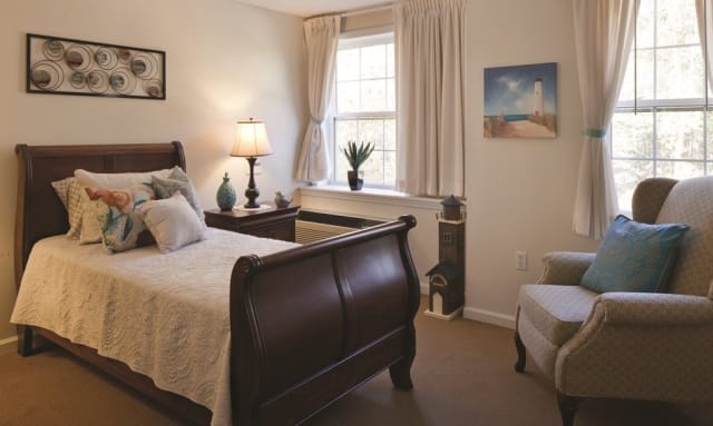 A cozy bedroom with elegant furnishings and soft lighting.