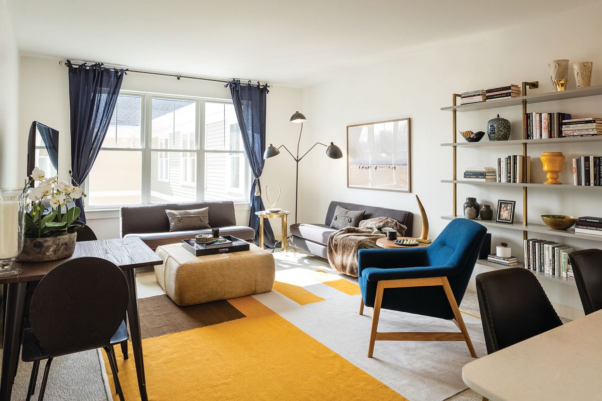 A modern living room with stylish furniture and vibrant accents.