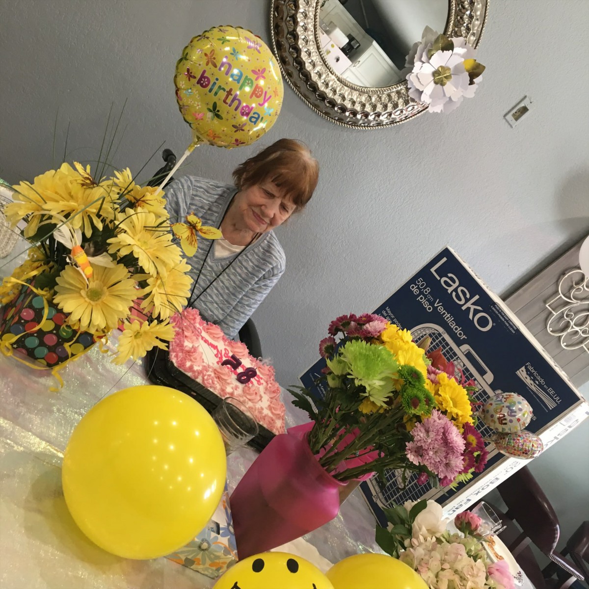 A festive setup with colorful balloons and flowers for a celebration.