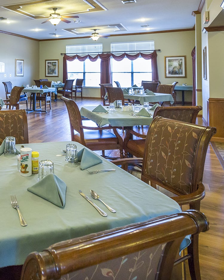An elegant dining room with neatly set tables and chairs.