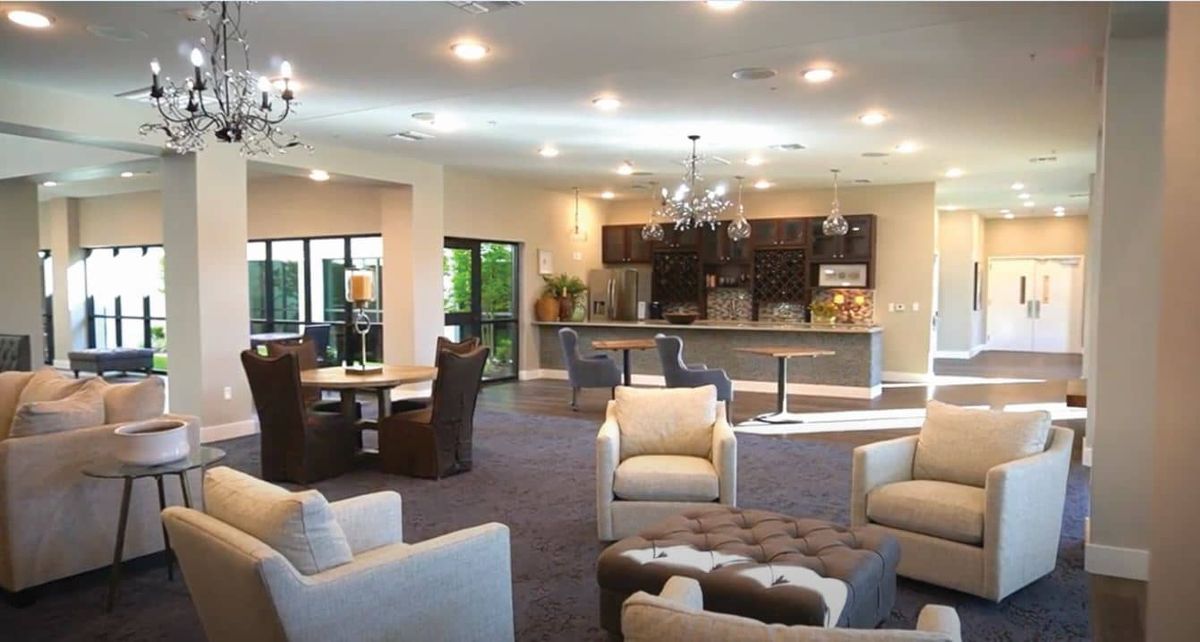 A modern open-concept living room with a kitchen and comfortable seating.