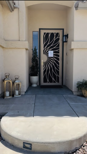 A stylish entrance featuring a decorative door and lanterns on the porch.