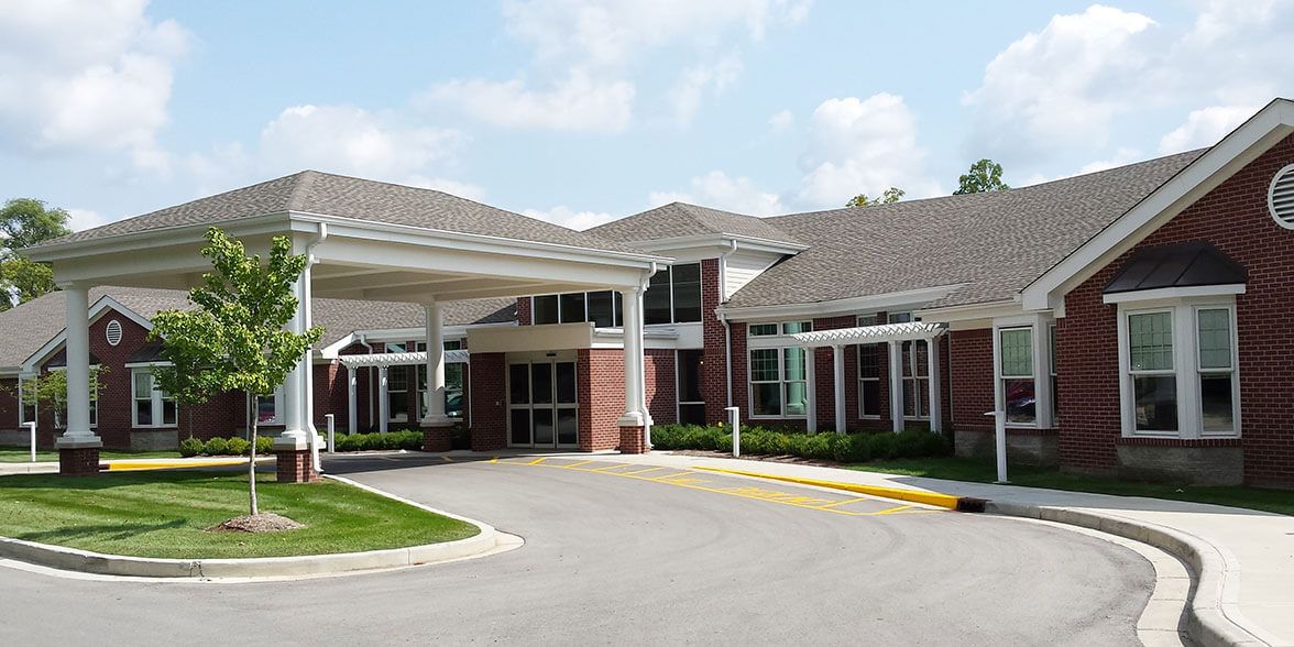 Front view of a hospital entrance with a driveway.
