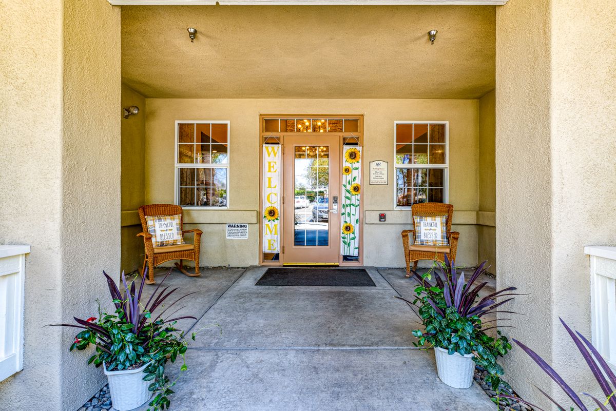 Inviting entrance with decorative glass door and cozy seating area.