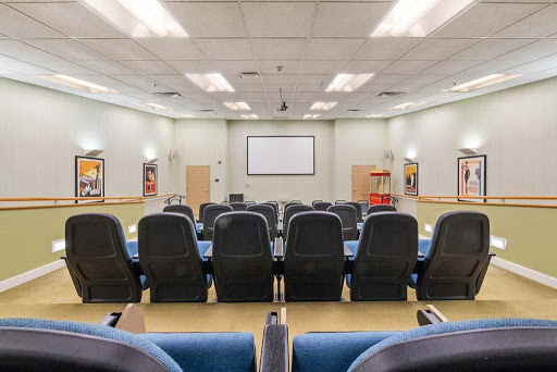 A spacious auditorium equipped with comfortable seating, designed for presentations and meetings.