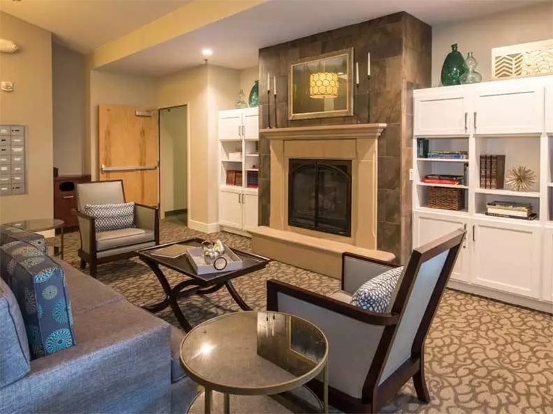 A modern living room with a fireplace and stylish furniture.