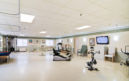 A spacious rehabilitation room equipped with exercise machines and therapy facilities.
