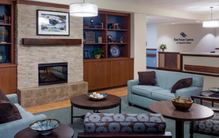 A modern living room with a cozy fireplace and stylish furniture.