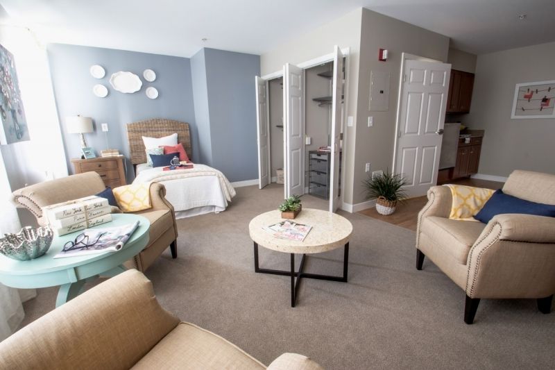 A cozy living and bedroom area with modern furniture and neutral decor.
