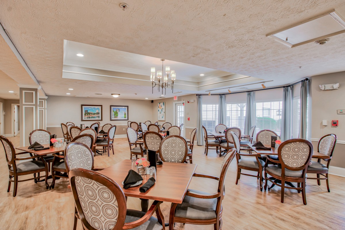 A spacious dining room with elegant furnishings and natural light.