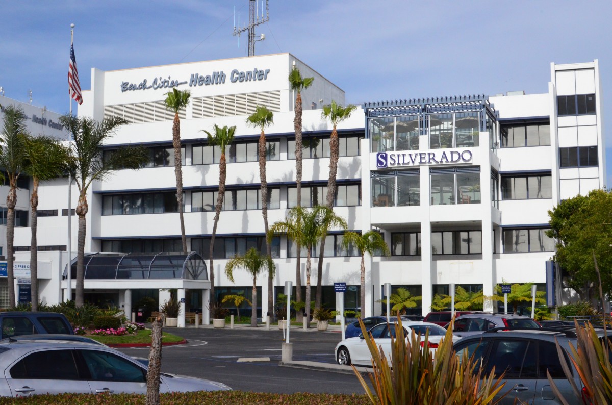 A health center building with signage for Silverado, surrounded by palm trees and a parking lot.