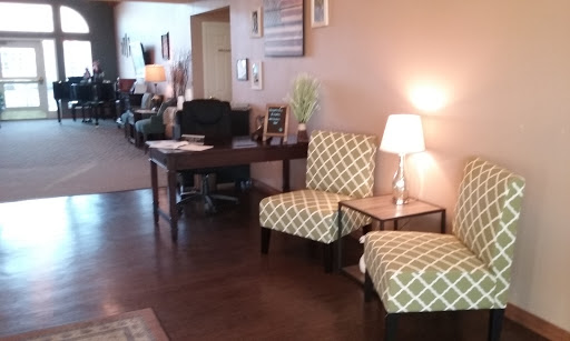 A cozy waiting area featuring stylish chairs and a table, creating a welcoming atmosphere.