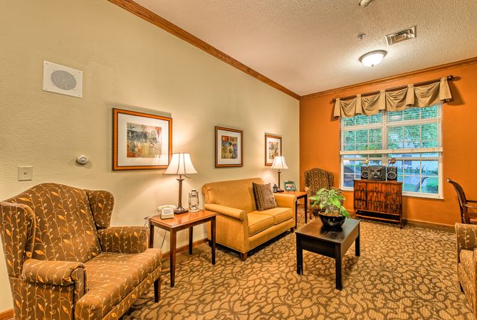A cozy living room with comfortable seating and warm lighting.