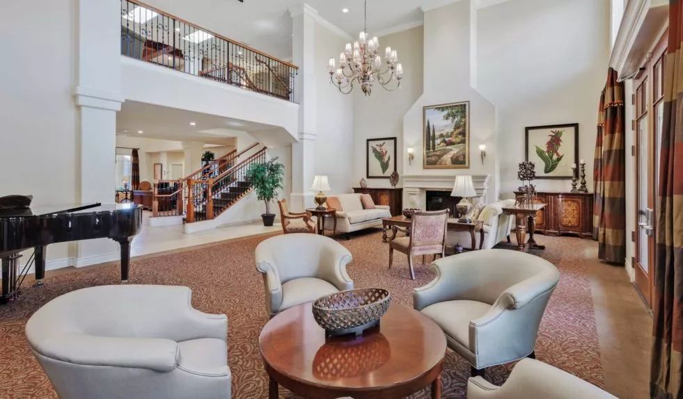 A spacious and elegant lobby with comfortable seating, a grand chandelier, and stylish decor.