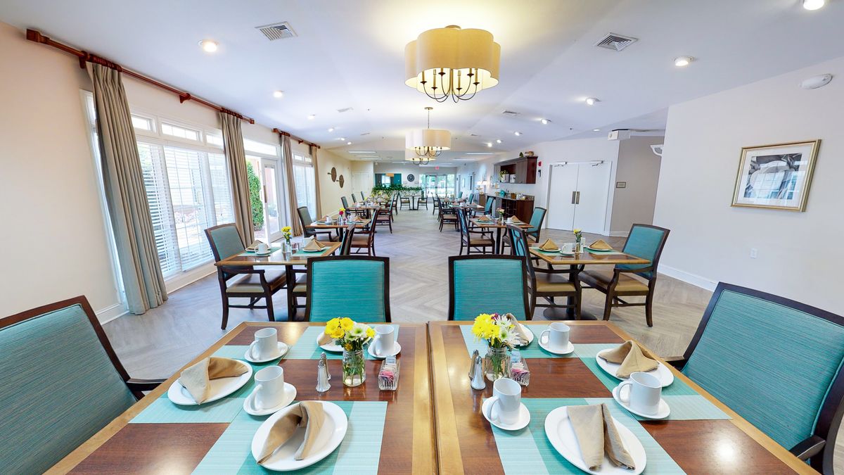 A well-arranged dining room with neatly set tables and elegant decor.