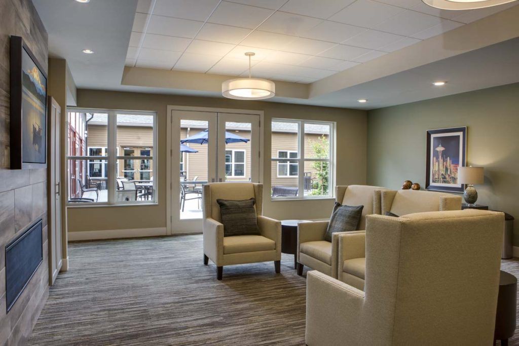 A modern living room with comfortable seating and large windows.