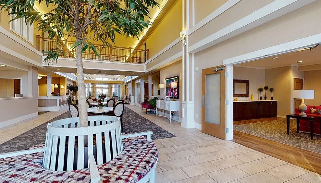 A spacious lobby with seating areas and decorative plants.