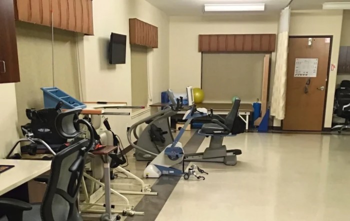 A small indoor gym with various exercise equipment including treadmills.