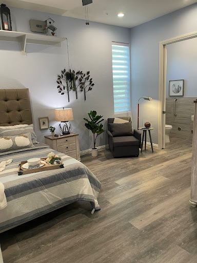 A serene and stylish bedroom featuring modern decor and cozy furnishings.
