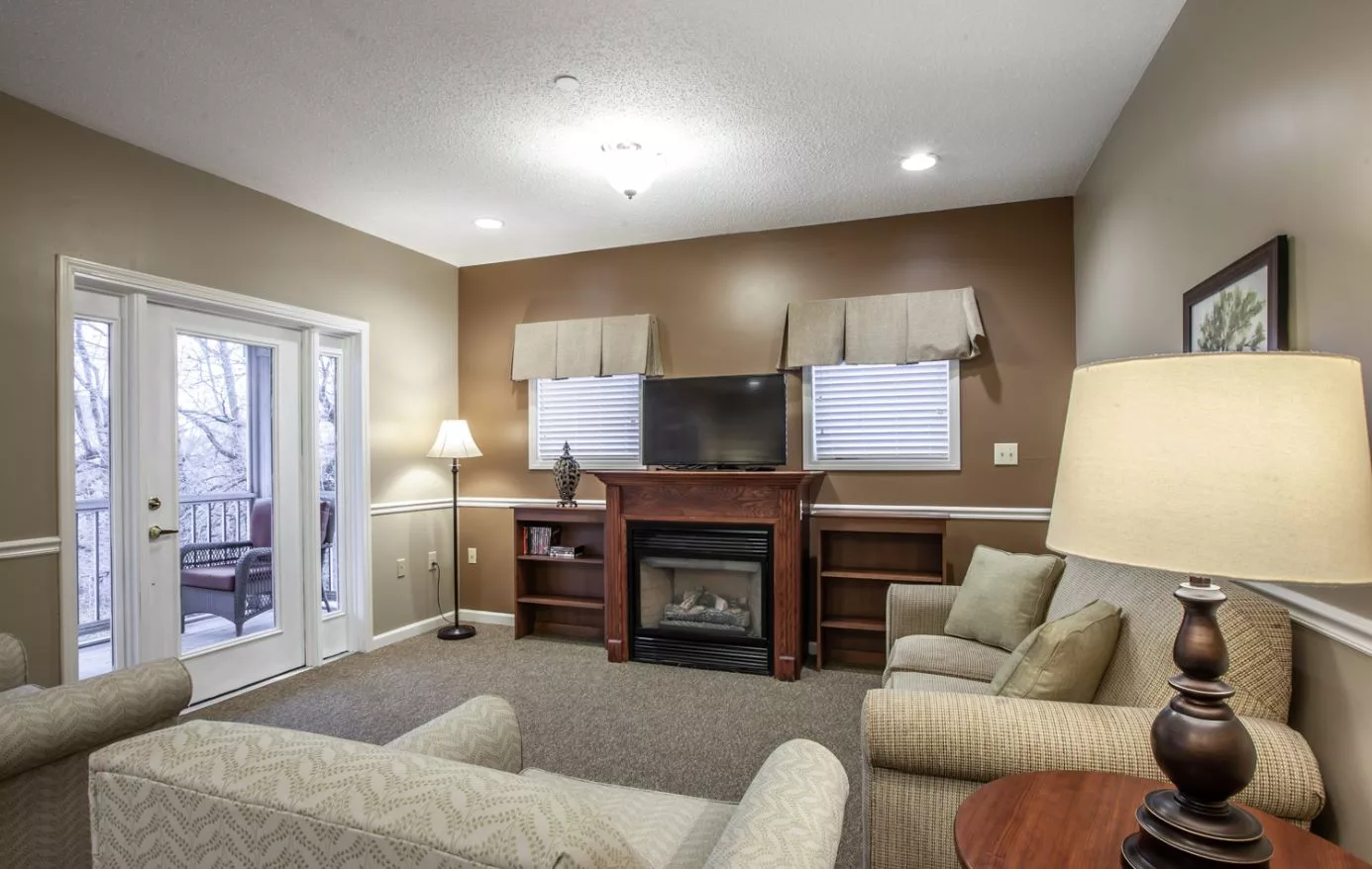 A cozy living room with a fireplace, television, and comfortable seating.
