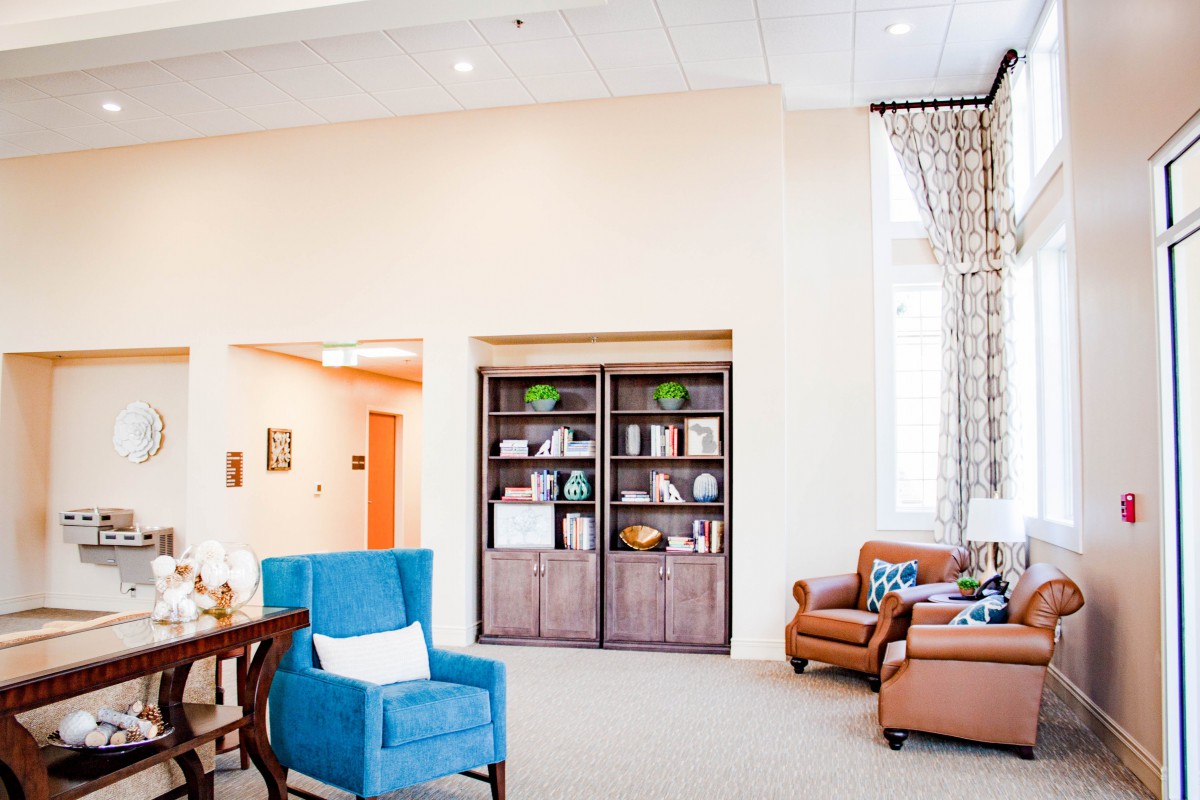 A cozy living room with comfortable seating and a stylish bookshelf.