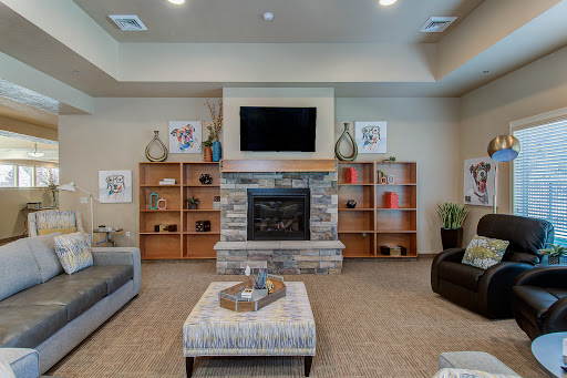 A cozy and modern living room featuring a stone fireplace and stylish furniture.