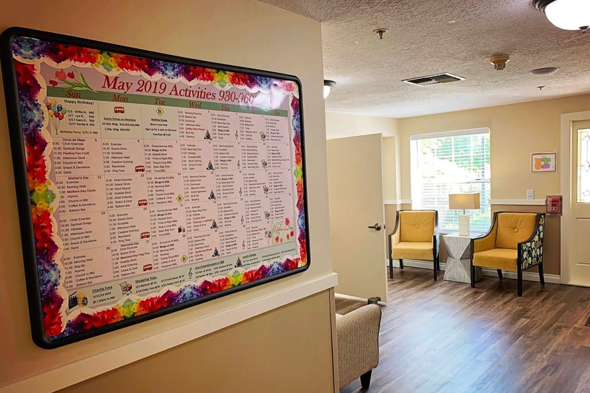 A cozy lobby with a colorful calendar on the wall and seating area.