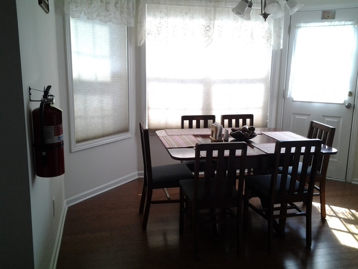 A cozy dining area with a table and chairs next to large windows.