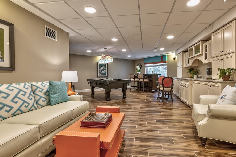 A modern basement game room featuring a foosball table, comfortable seating, and stylish decor.