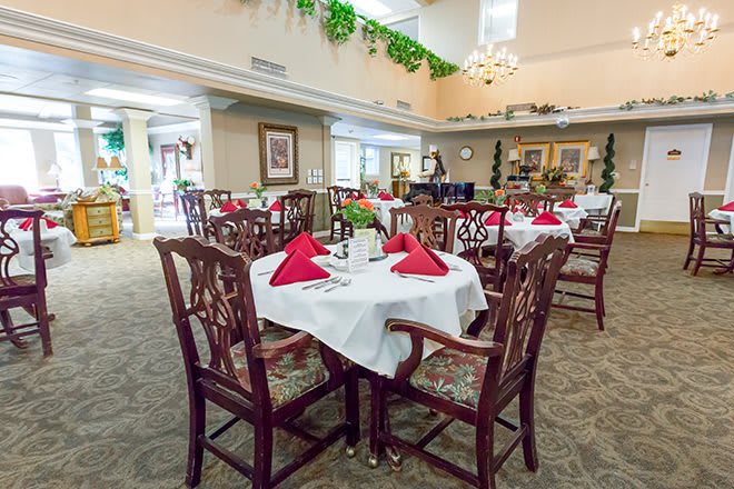 A spacious and elegantly decorated dining area with tables set for a meal.