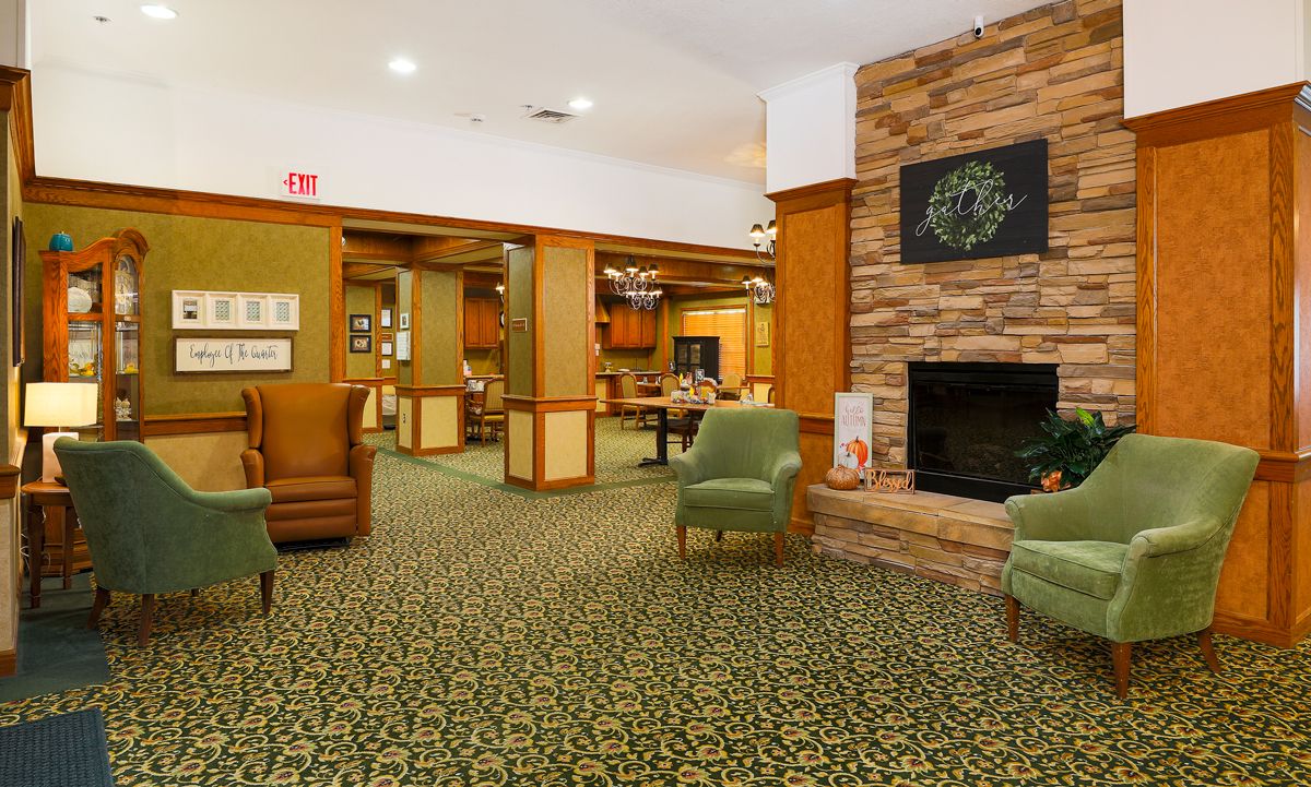 A cozy hotel lobby with comfortable seating and a fireplace.