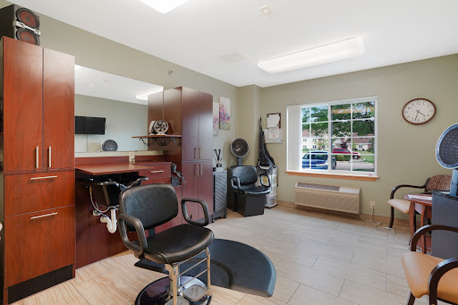 A well-lit and modern salon interior featuring styling chairs and a welcoming atmosphere.
