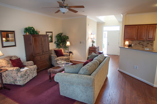 A cozy living room featuring comfortable seating, warm lighting, and inviting decor.