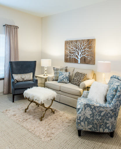 A cozy and elegantly designed living room featuring a comfortable sofa and stylish armchairs.