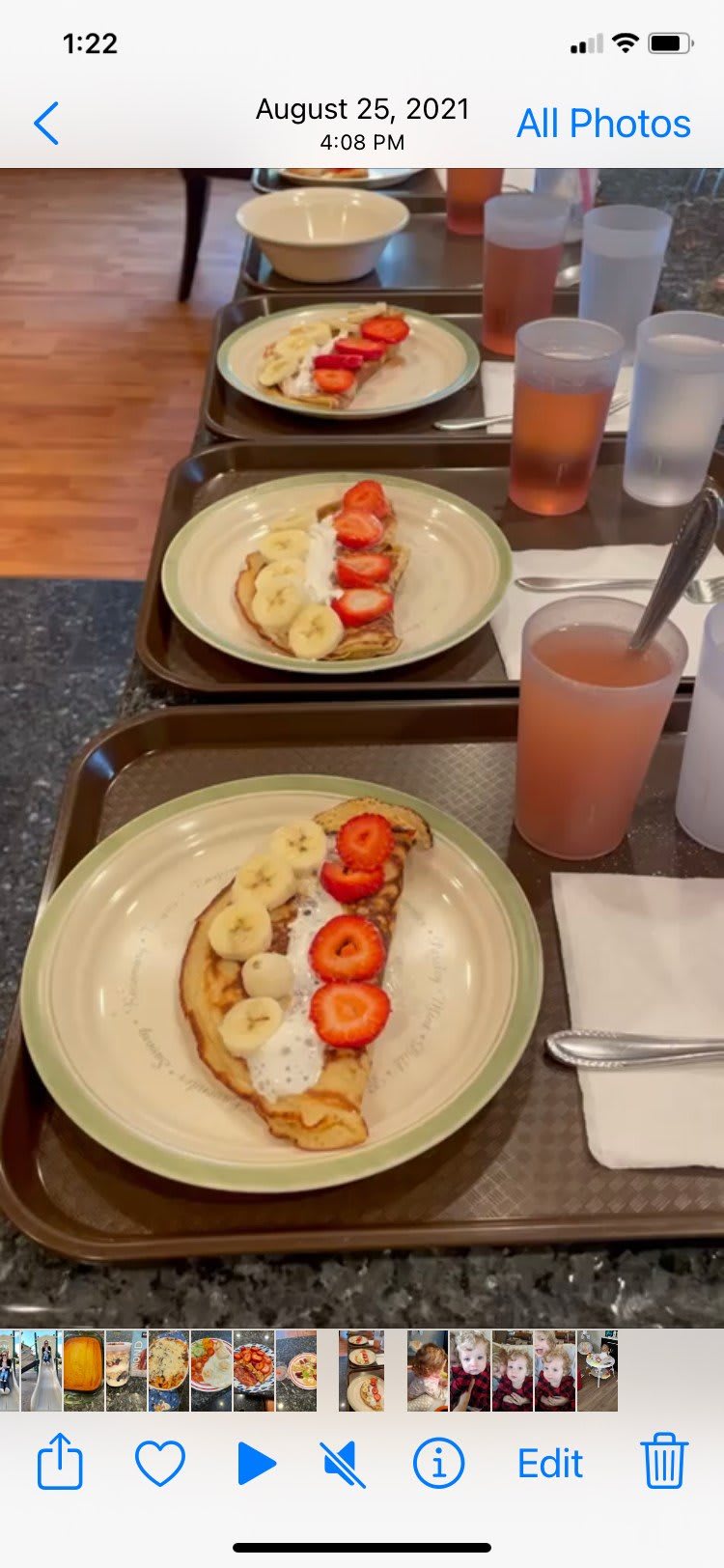 A delicious breakfast featuring toast topped with strawberries, bananas, and whipped cream, served with a refreshing drink.