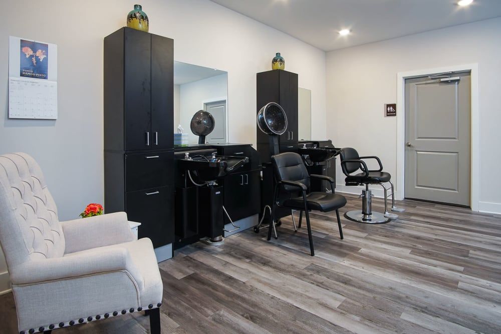 A modern hair salon with styling chairs and mirrors.