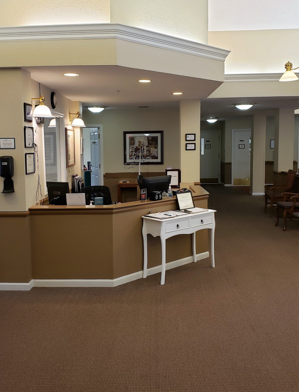 A welcoming reception area with a neatly arranged desk and warm lighting.