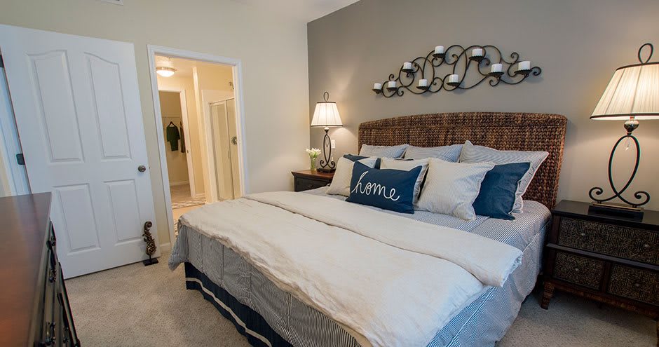 Cozy bedroom with a stylish bed and elegant lighting.