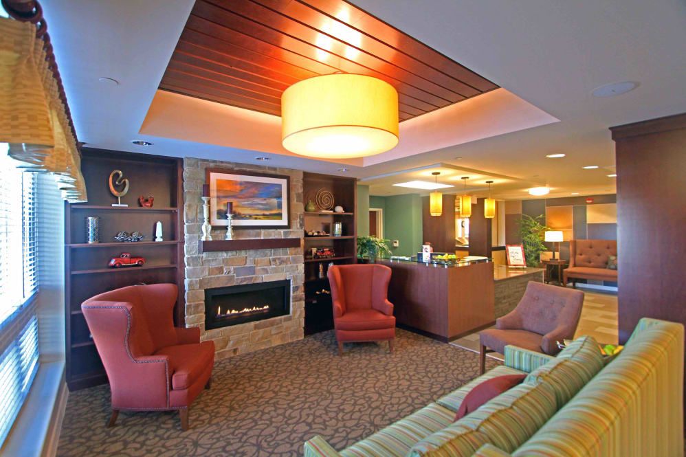 A cozy living room interior with comfortable seating and warm lighting.