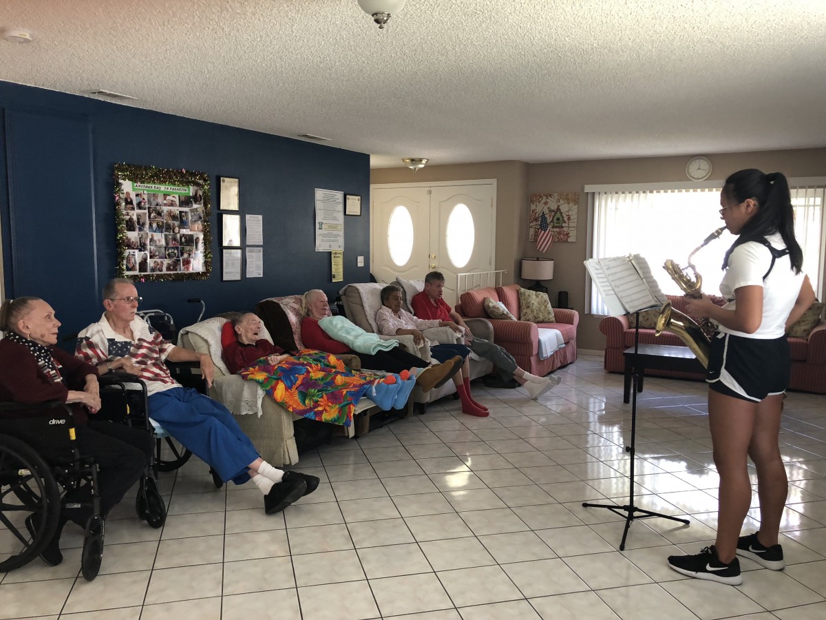 A group of people relaxing on couches in a living room setting.