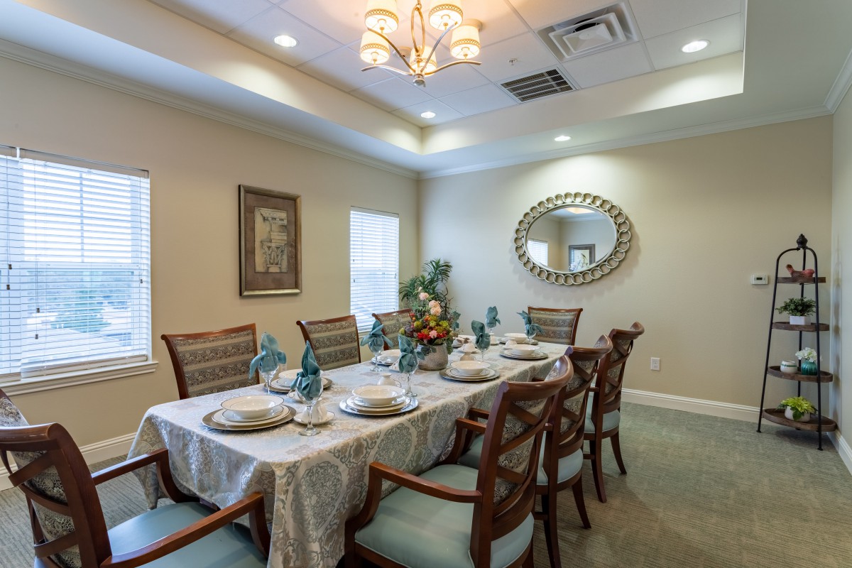 A beautifully decorated dining room with an elegant table setting and chandelier.