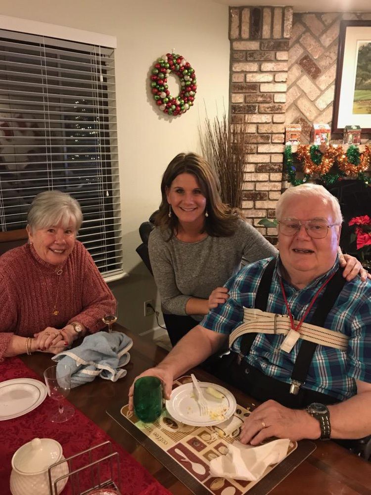 A family gathered around a table enjoying a meal together.