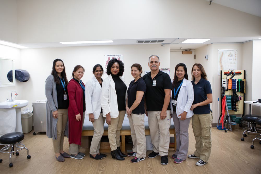 A group of healthcare professionals posing together indoors.
