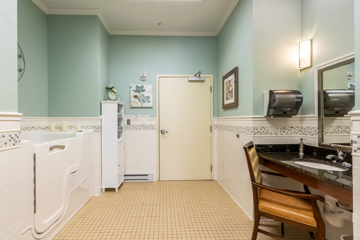 A cozy laundry room with a washer and dryer, featuring soft pastel walls and stylish furniture.