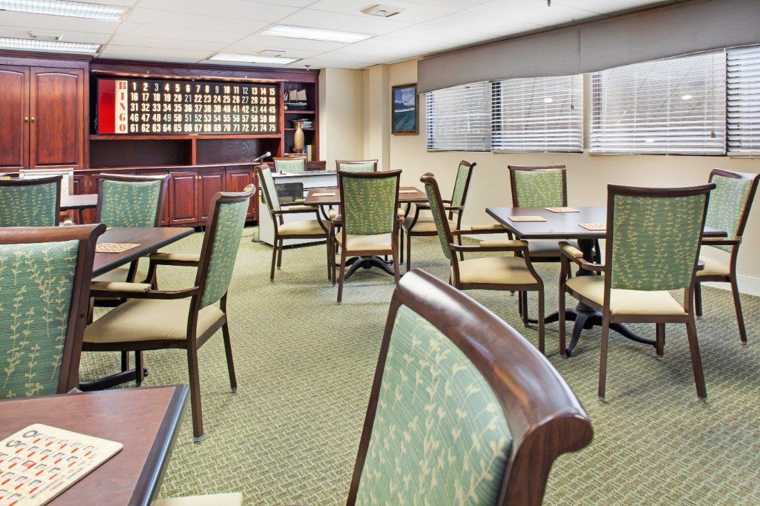 A well-lit conference room with several tables and chairs arranged for meetings.