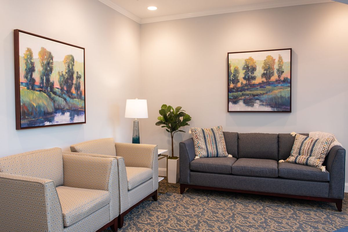A cozy living room with modern furniture and decorative artwork.