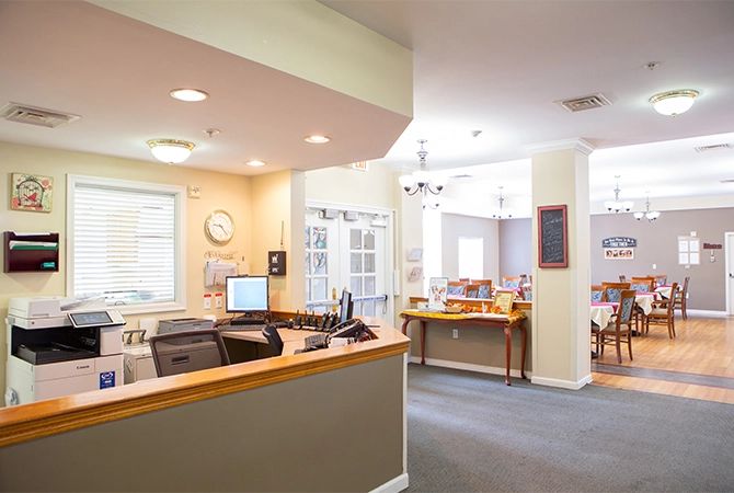 A modern office reception area with a desk and computer in a bright, well-lit space.
