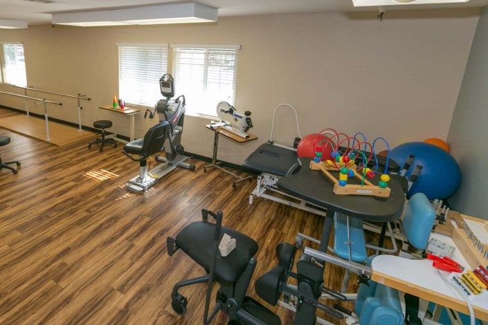 A rehabilitation room equipped with therapy tools and exercise equipment.
