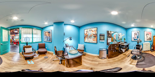 A modern office space featuring vibrant blue walls and artistic decor.